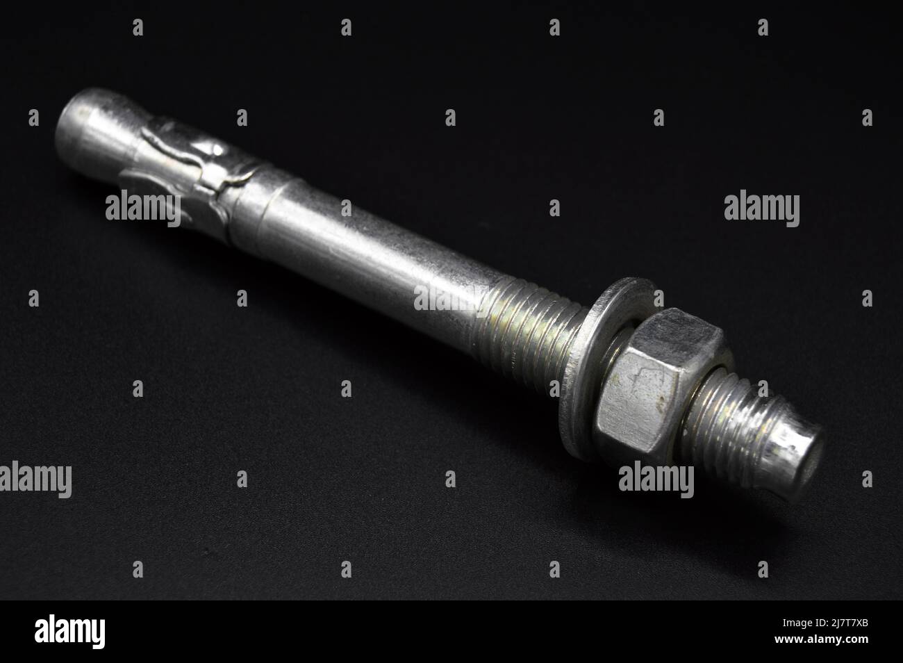 Galvanized steel metal dowel with metric bolt and nut, isolated on