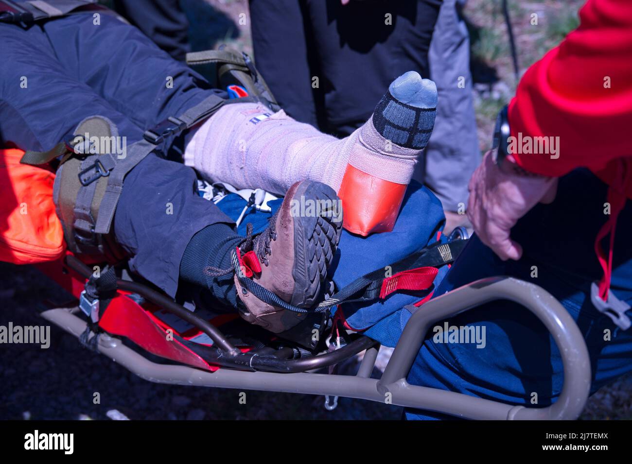 Paramedics from mountain rescue service provide first aid to person