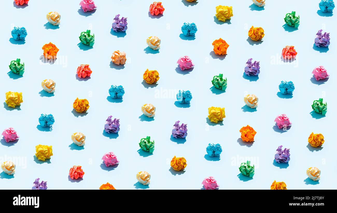 Multicolored crumpled paper balls on blue Stock Photo