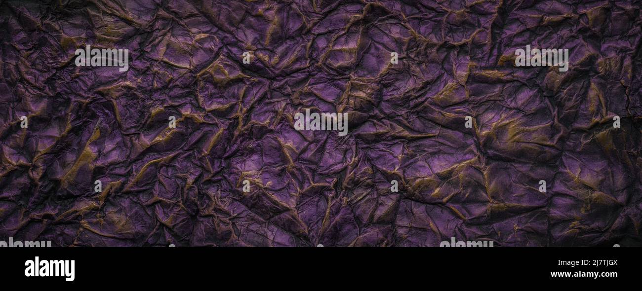 Dark purple with gold paint crumpled paper texture background Stock Photo