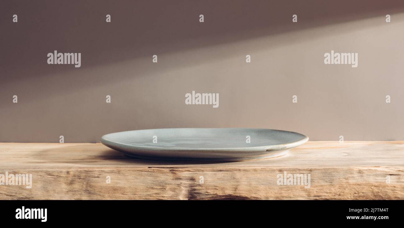 Empty plate on a wooden table or bar Stock Photo