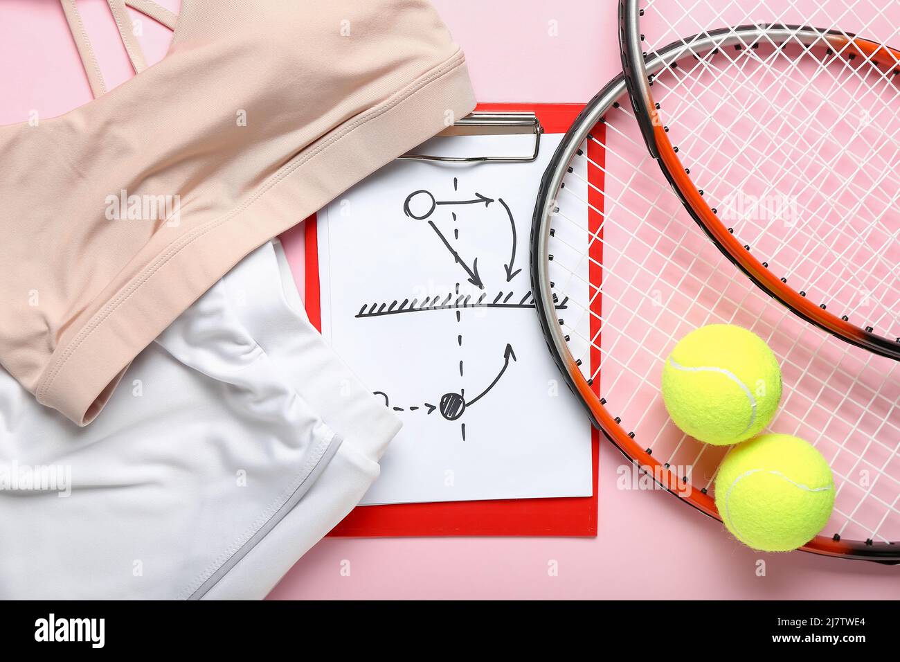 Clipboard with drawn scheme of tennis game, rackets, balls and sportswear on pink background