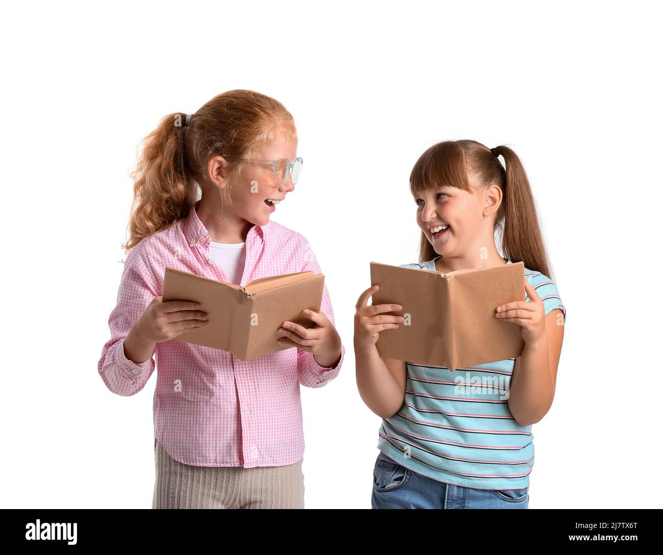Little girls with books on white background Stock Photo - Alamy