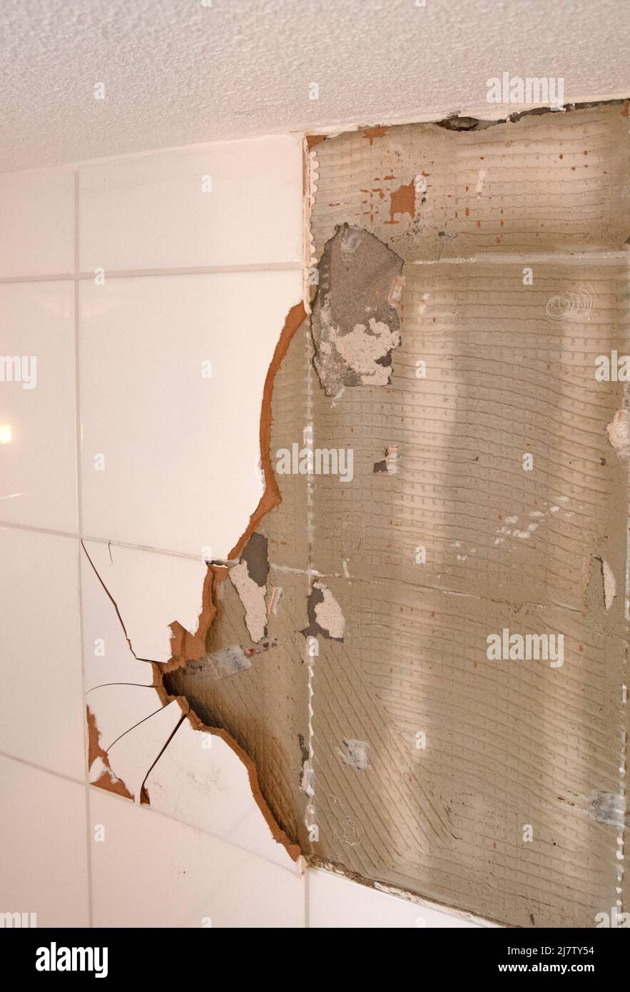 Breaking ceramic tiles, work in progress, maintenance Stock Photo Alamy