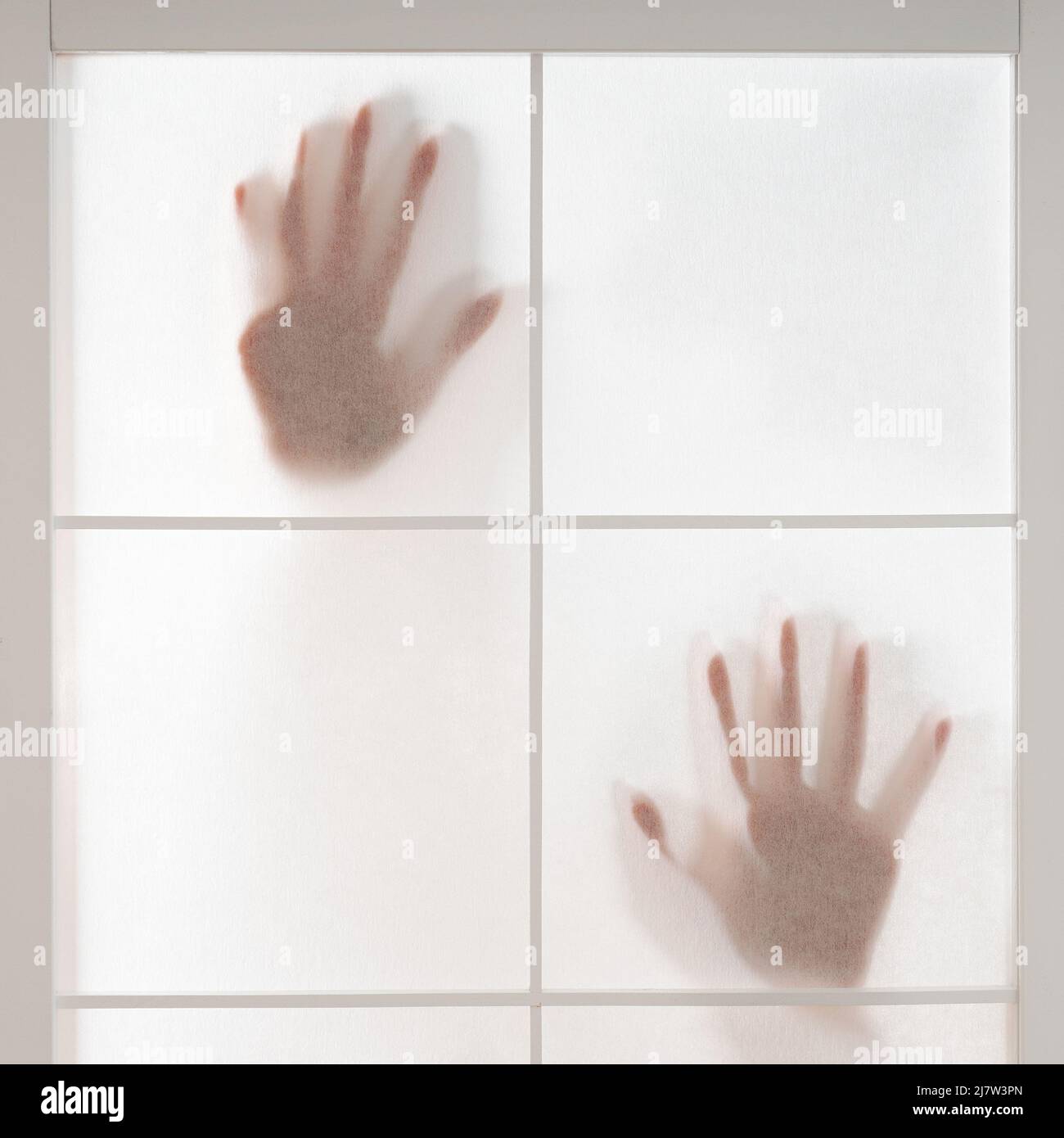 silhouette of hands trapped behind translucent screen Stock Photo