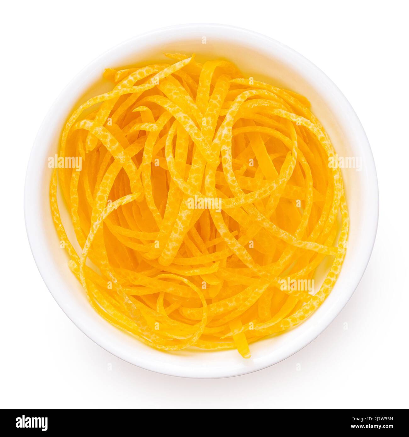 Freshly peeled lemon zest in a white ceramic bowl isolated on white. Top view. Stock Photo