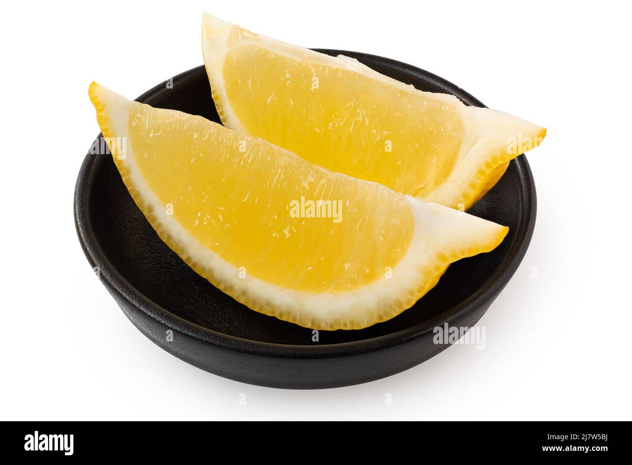 Two segments of fresh lemon in black ceramic dish isolated on white. Stock Photo