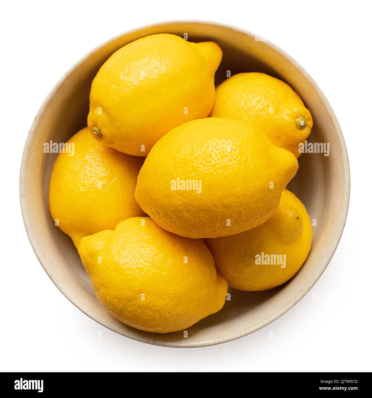 Whole fresh lemons in light rustic bowl isolated on white. Top view. Stock Photo