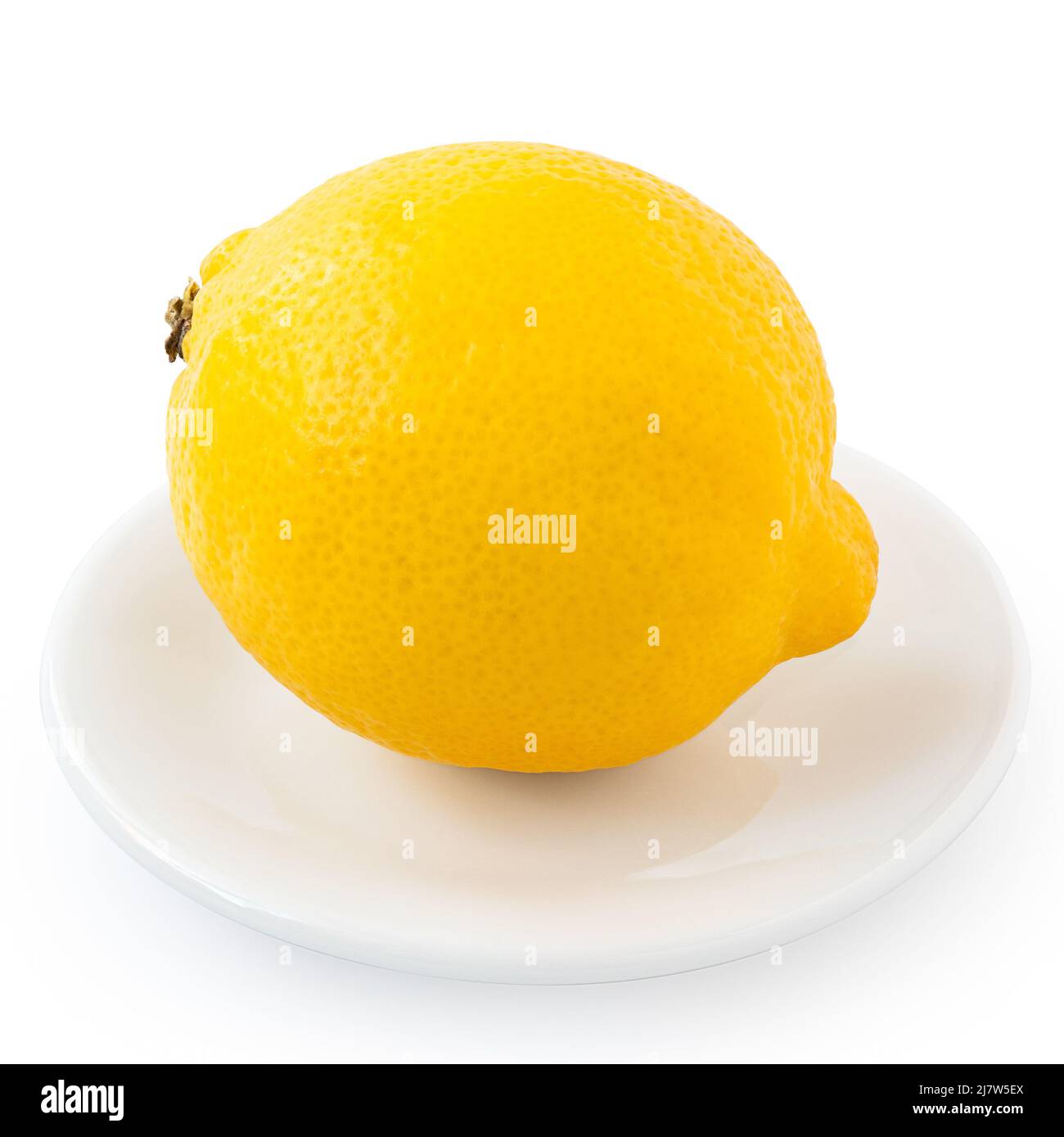Whole fresh lemon on white ceramic plate isolated on white. Stock Photo