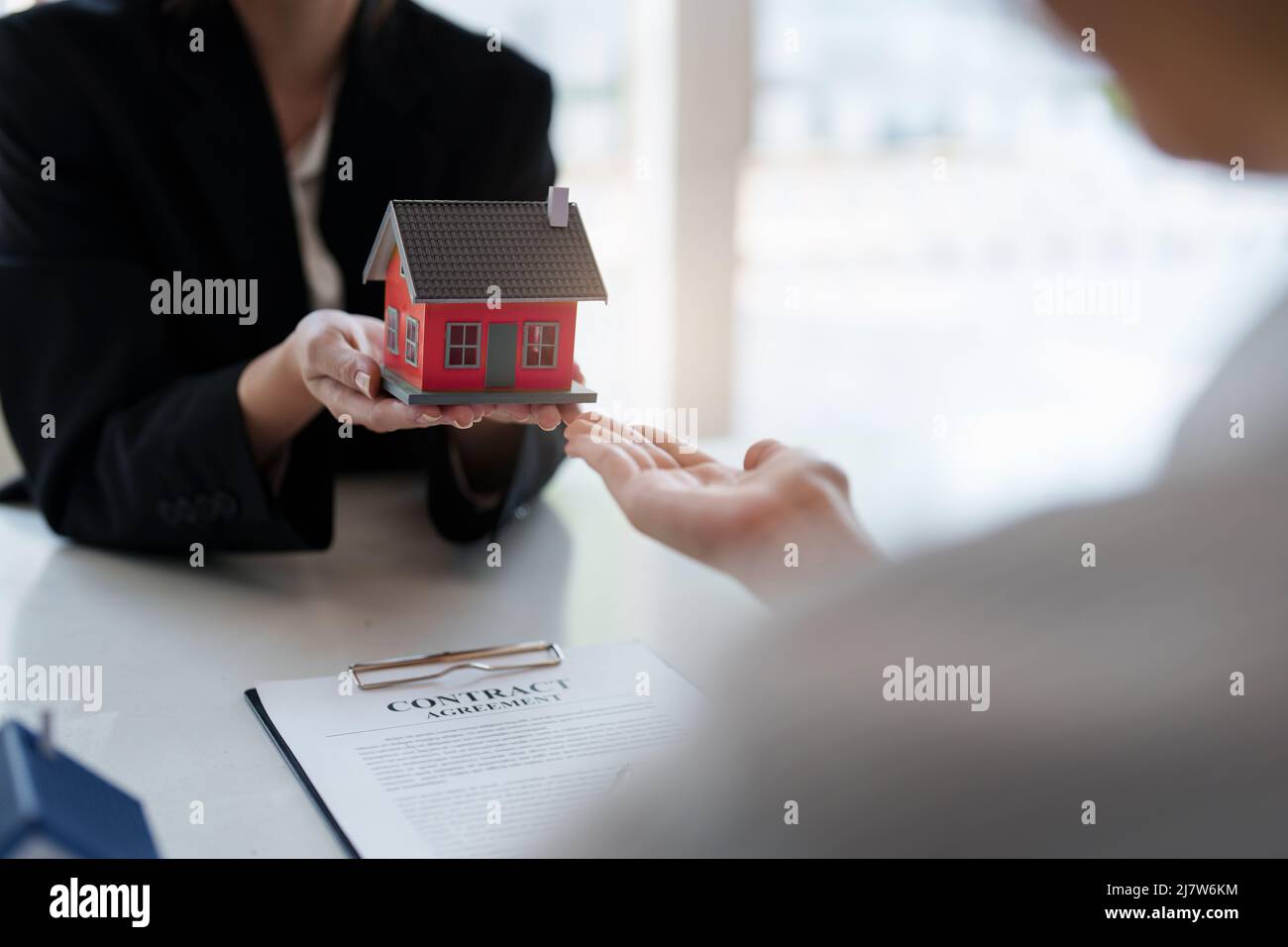 Close up Business woman or Real Estate agent explain signing agreement ...