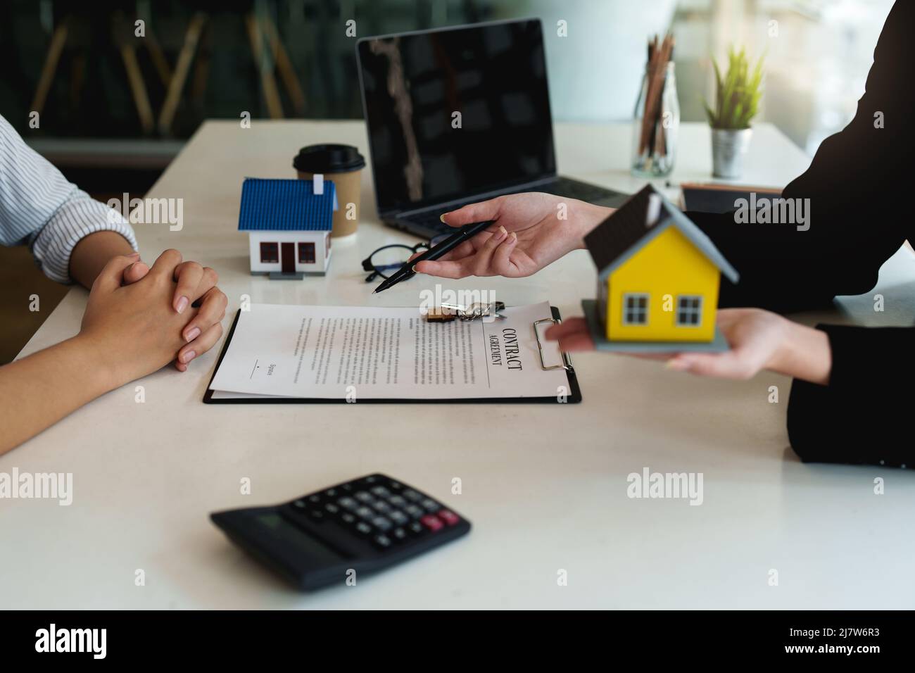 Close up Business woman or Real Estate agent explain signing agreement ...