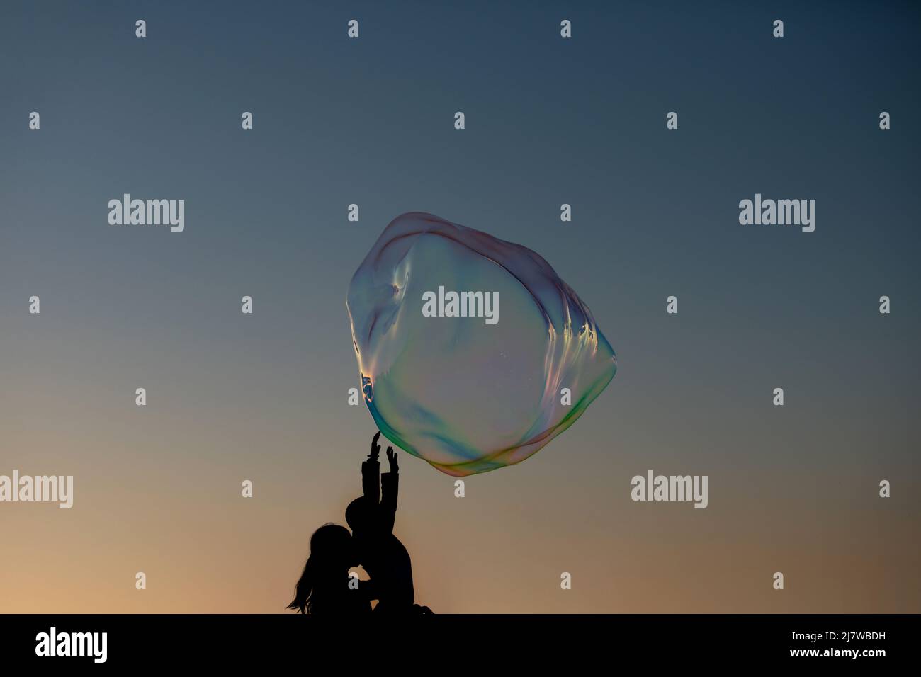 Soap bubbles. Hands trying to catch floating soap bubbles. Bubble show