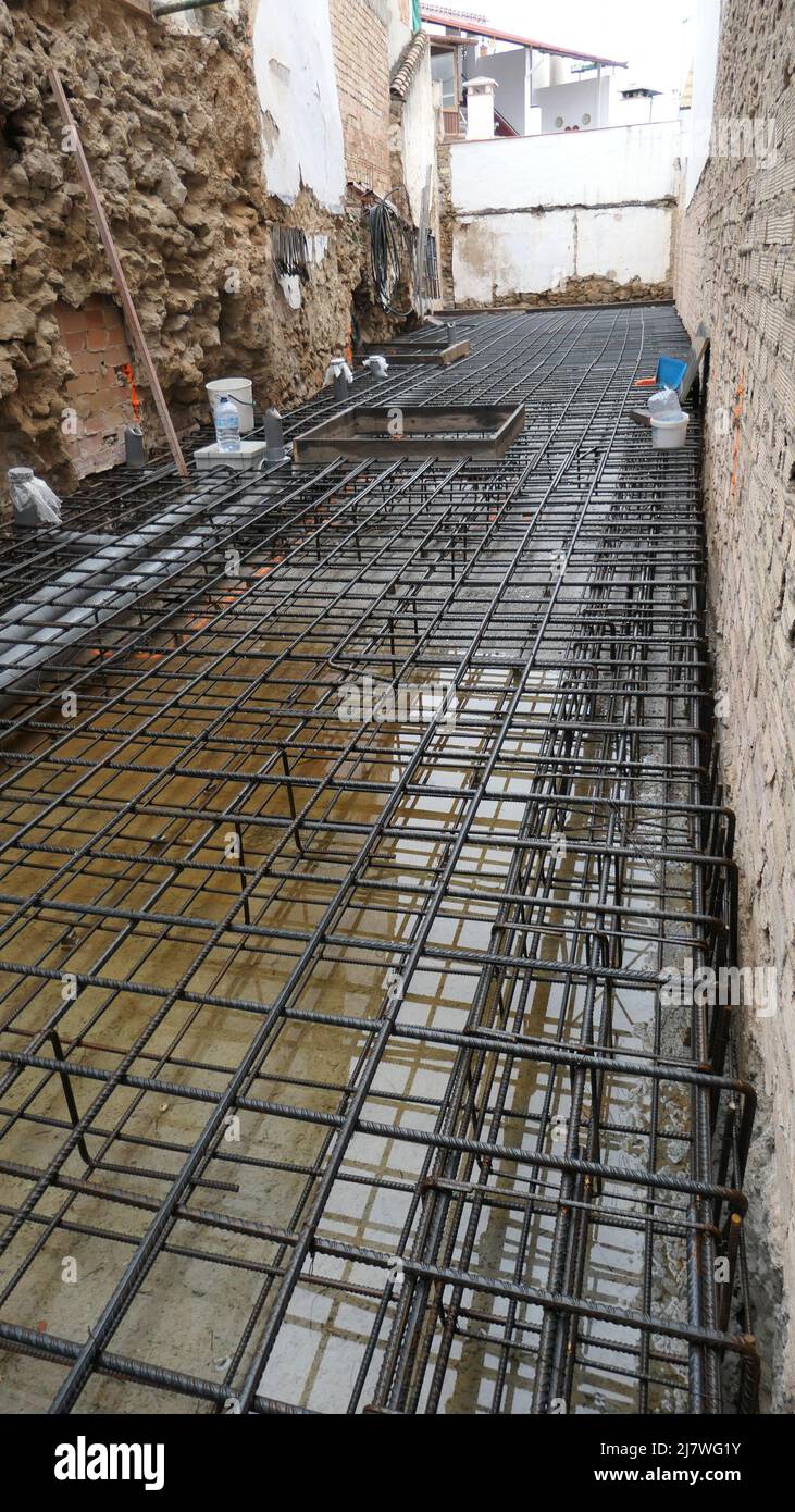 Steel bars awaiting pumped and poured concrete at construction site in central Andalusian village Stock Photo