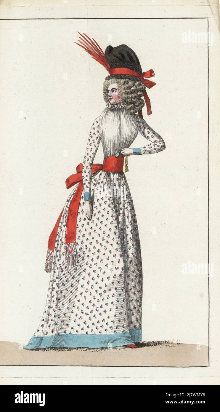 Woman in robe a la Constitution. Black gauze demi-casque bonnet with scarlet ribbon and aigrette, linen fichu, gown and petticoat in fine Indian cotton sewn with bouquets, sash belt, hemmed with sky-blue ribbon, nakara slippers.Handcoloured copperplate engraving from Jean-Antoine le Brun or Lebrun-Tossa’s Journal de la Mode et du Gout, previously Cabinet des Modes, Chez Buisson, Paris, and Joseph le Boffe, London, 6me Cahier, 15 April 1790. Stock Photo