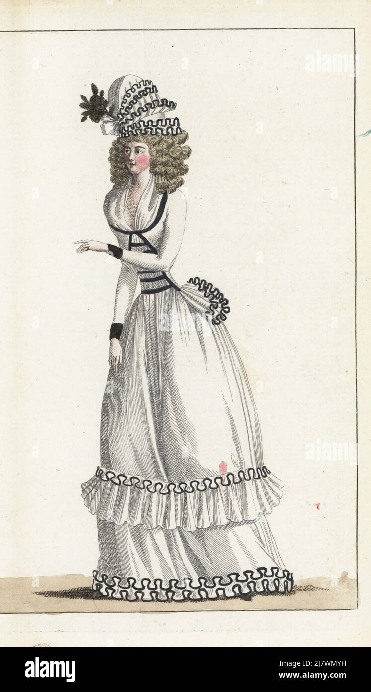 Woman in demi-deuil or mourning dress. White crepe bonnet with black ribbon, hair in large curls, white fichu, white crepe caraco jacket bordered in black ribbon, white crepe petticoat with falbala ruffle. Handcoloured copperplate engraving from Jean-Antoine le Brun or Lebrun-Tossa’s Journal de la Mode et du Gout, previously Cabinet des Modes, Chez Buisson, Paris, and Joseph le Boffe, London, 7me Cahier, 25 April 1790. Stock Photo