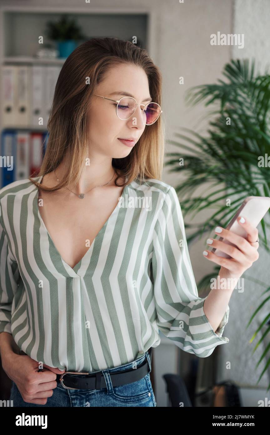 Young woman working on a computer in her office Stock Photo - Alamy