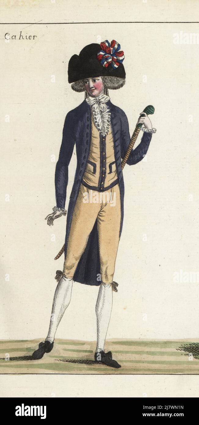 Fashionable man in bicorne with tricolor cockade, cravate, orange cashmere gilet and culottes, violet coat with sky-blue collet and goatskin buttons, rosette shoes, cane sabre with green poignee. Handcoloured copperplate engraving from Jean-Antoine le Brun or Lebrun-Tossa’s Journal de la Mode et du Gout, previously Cabinet des Modes, Chez Buisson, Paris, and Joseph le Boffe, London, 9me Cahier, 15 May 1790. Stock Photo