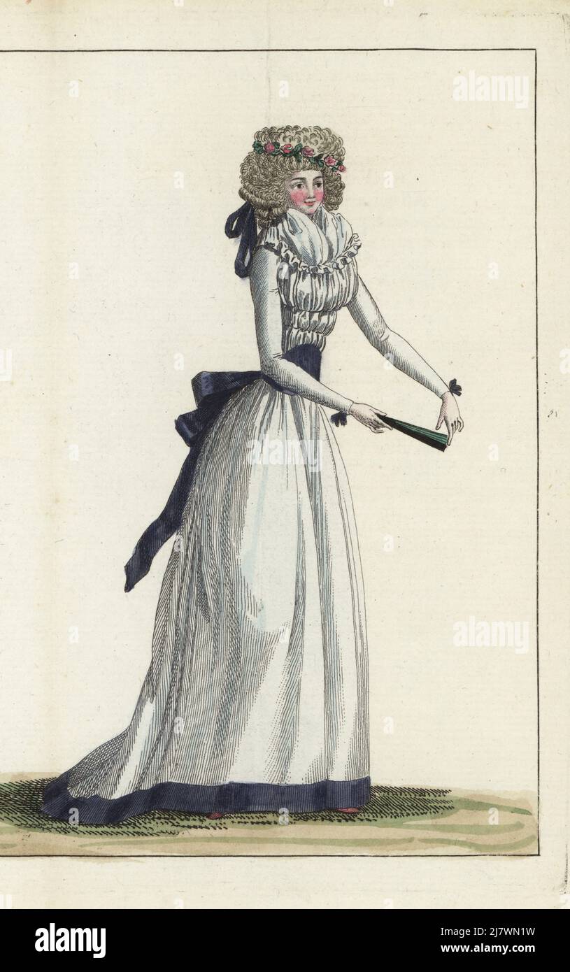 Fashionable woman in hairstyle a l'enfant: herisson or hedgehog crown with roses, rows of ringlets tied behind with a violet ribbon. In white linen gown, fourreau, violet ribbon belt and hem, gauze fichu, holding a fan. Handcoloured copperplate engraving from Jean-Antoine le Brun or Lebrun-Tossa’s Journal de la Mode et du Gout, previously Cabinet des Modes, Chez Buisson, Paris, and Joseph le Boffe, London, 9me Cahier, 15 May 1790. Stock Photo