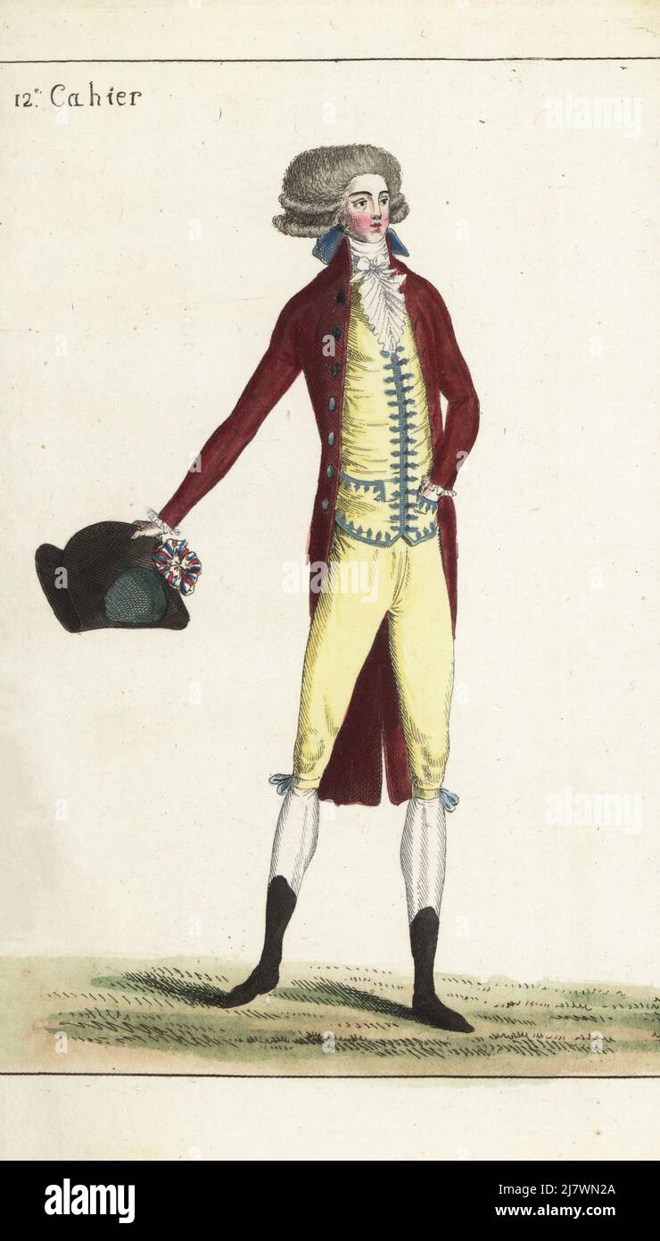 Man in hairstyle with two curls, wine-red coat, batiste cravatte, silk gilet and matching culottes, garters with blue bows, white silk hose, English bootlets. Holding a bicorne with tricolor cockade. Handcoloured copperplate engraving from Jean-Antoine le Brun or Lebrun-Tossa’s Journal de la Mode et du Gout, previously Cabinet des Modes, Chez Buisson, Paris, and Joseph le Boffe, London, 12me Cahier, 15 June 1790. Stock Photo