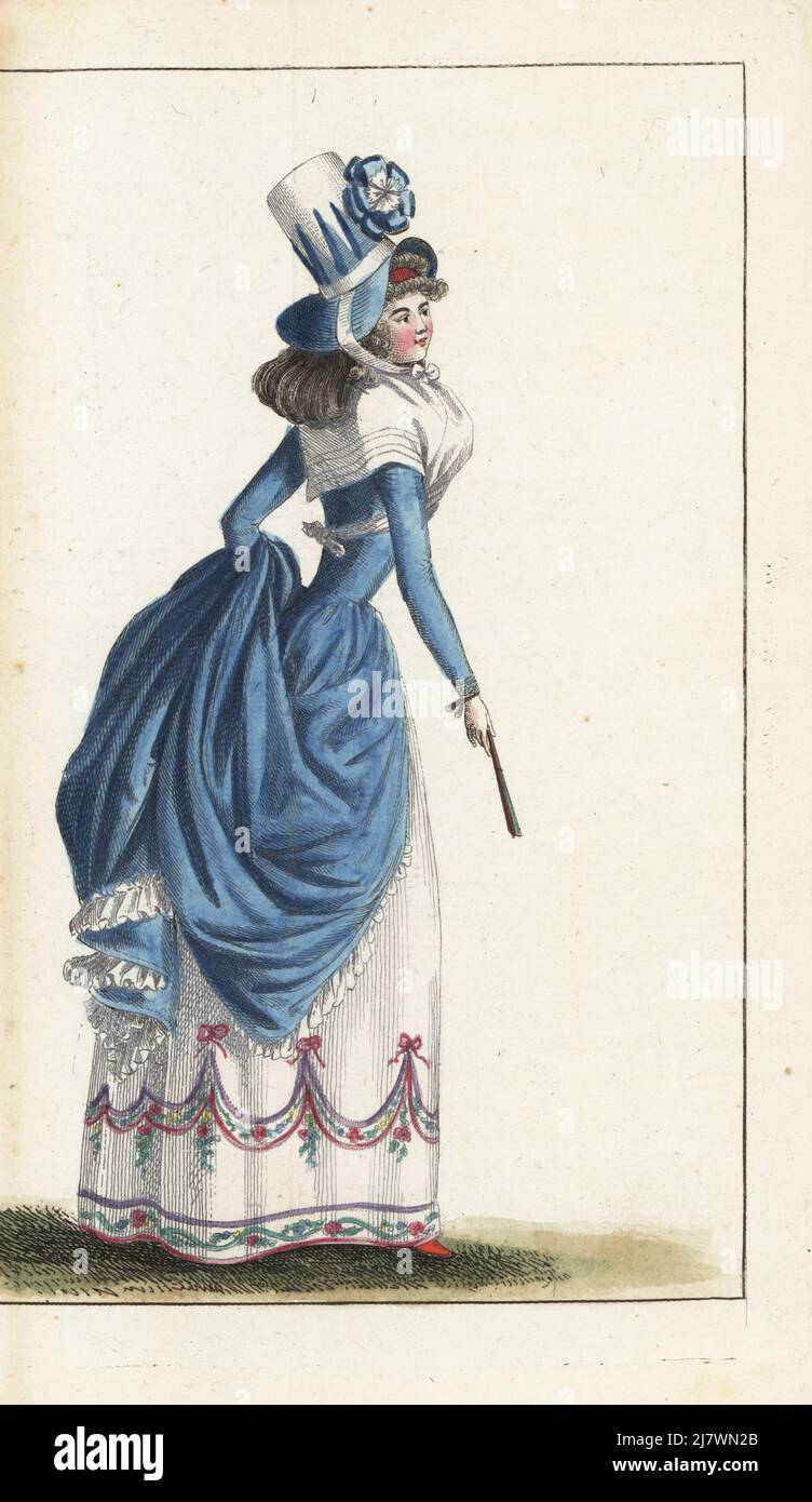 Woman in English fashion in blue bonnet, taffeta gown, gauze fichu, linen skirts with ruffles, nakara slippers. Handcoloured copperplate engraving from Jean-Antoine le Brun or Lebrun-Tossa’s Journal de la Mode et du Gout, previously Cabinet des Modes, Chez Buisson, Paris, and Joseph le Boffe, London, 12me Cahier, 15 June 1790. Stock Photo