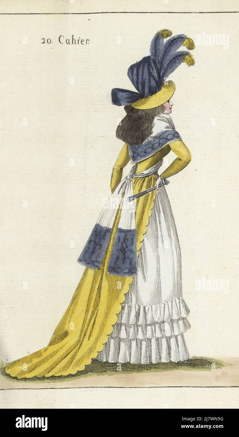 Woman in tall yellow hat covered in violet taffeta, heron plumes, hair in ringlets. Yellow taffeta gown, large fichu decorated with violet arabesques, white gauze petticoat with falbalas, violet fan. Handcoloured copperplate engraving from Jean-Antoine le Brun or Lebrun-Tossa’s Journal de la Mode et du Gout, previously Cabinet des Modes, Chez Buisson, Paris, and Joseph le Boffe, London, 20me Cahier, 5 September 1790. Stock Photo