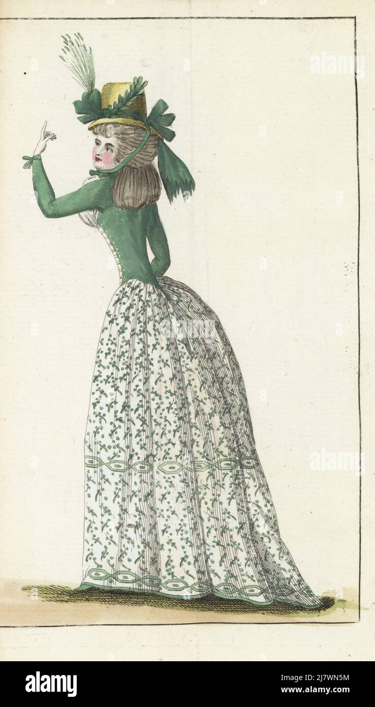 Woman in hat a la Jardiniere in yellow straw with green ribbons. Hair in hanging toupets, unpowdered. Green taffeta corset, gauze chemise fichu, embroidered linen petticoat, green slippers. Handcoloured copperplate engraving from Jean-Antoine le Brun or Lebrun-Tossa’s Journal de la Mode et du Gout, previously Cabinet des Modes, Chez Buisson, Paris, and Joseph le Boffe, London, 20me Cahier, 5 September 1790. Stock Photo