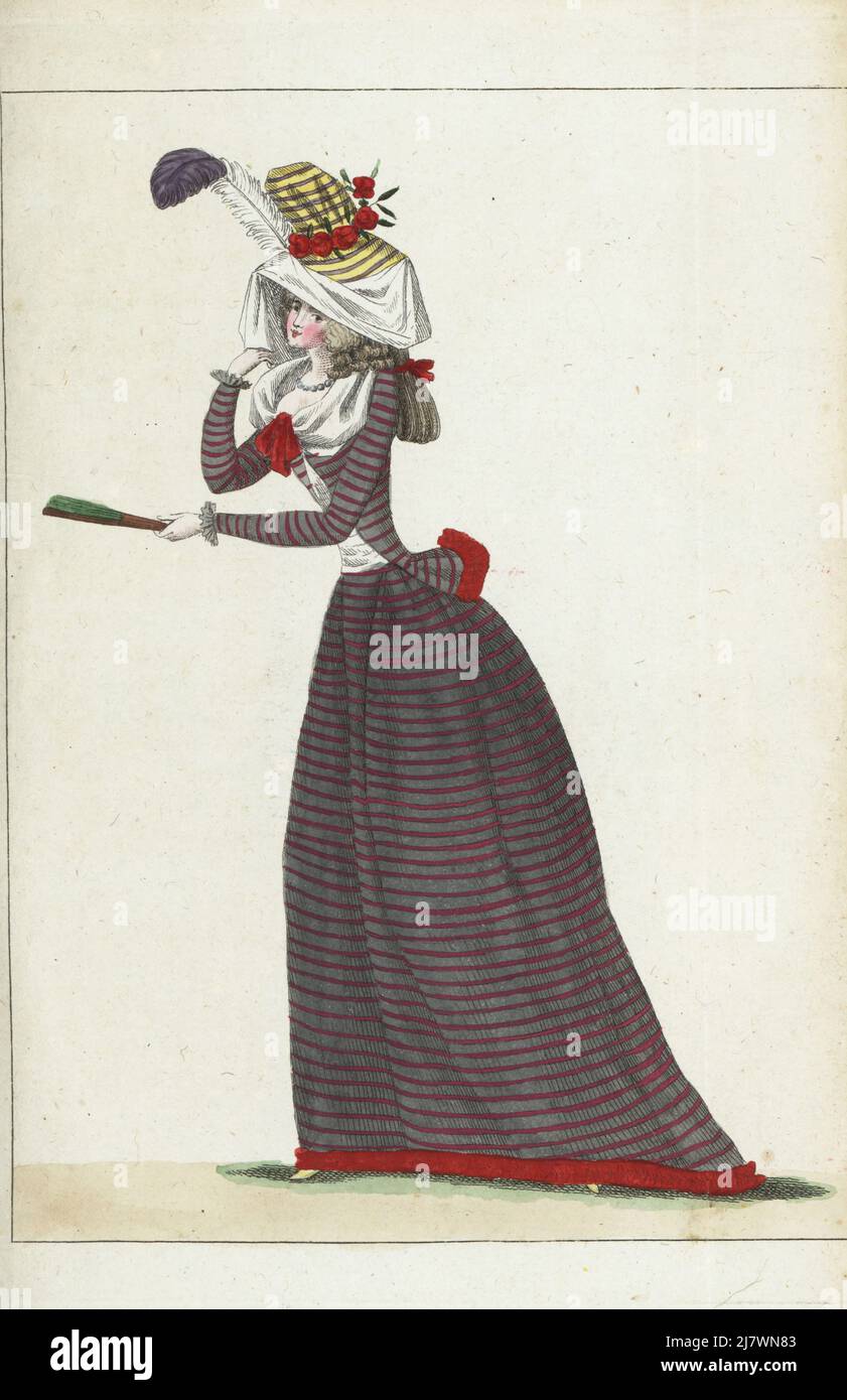 Woman in striped taffeta bonnet with pomegranate flowers and gauze veil, hair in ringlets, black striped gauze coureur or caraco jacket, matching petticoat, lemon slippers. Handcoloured copperplate engraving from Jean-Antoine le Brun or Lebrun-Tossa’s Journal de la Mode et du Gout, previously Cabinet des Modes, Chez Buisson, Paris, and Joseph le Boffe, London, 25me Cahier, 25 October 1790. Stock Photo