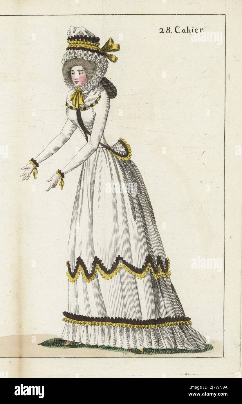 Woman in gauze bonnet with yellow and suie ribbon, white linen caraco and petticoat, silver buttons, gauze fichu, yellow slippers. Handcoloured copperplate engraving from Jean-Antoine le Brun or Lebrun-Tossa’s Journal de la Mode et du Gout, previously Cabinet des Modes, Chez Buisson, Paris, and Joseph le Boffe, London, 28me Cahier, 25 November 1790. Stock Photo