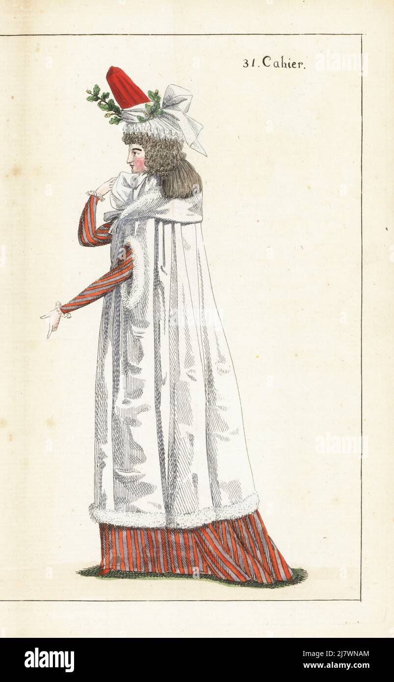 Woman in bonnet of red satin and white gauze with oak sprig, hair in pressed ringlets, white satin fur-lined pelisse, striped violet and marigold gown and petticoat, marigold slippers. Handcoloured copperplate engraving from Jean-Antoine le Brun or Lebrun-Tossa’s Journal de la Mode et du Gout, previously Cabinet des Modes, Chez Buisson, Paris, and Joseph le Boffe, London, 31me Cahier, 25 December 1790. Stock Photo