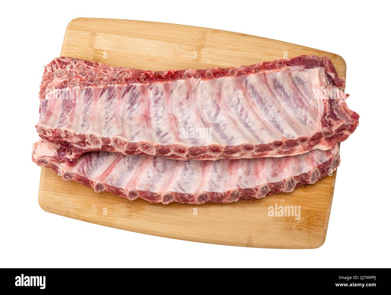 Raw pork spare loin ribs St Louis cut offered. closeup top view on wooden board. Racks of fresh raw pork meat ribs isolated on white background Stock Photo