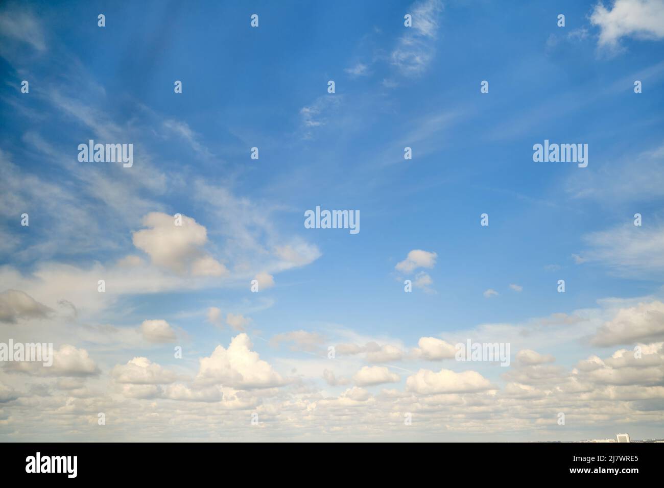 White cumulus clouds in the blue sky. Bright beautiful sky, copy space ...