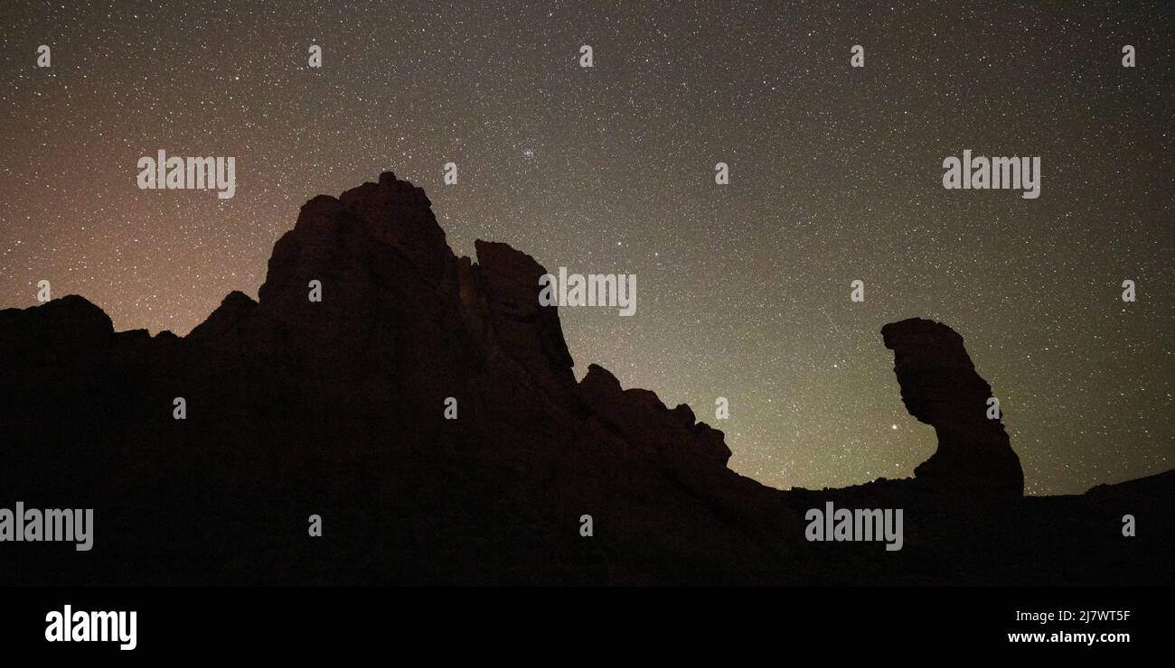 Stars in the night sky above the Roques de García in Teide National Park on Tenerife, Spain. Stock Photo