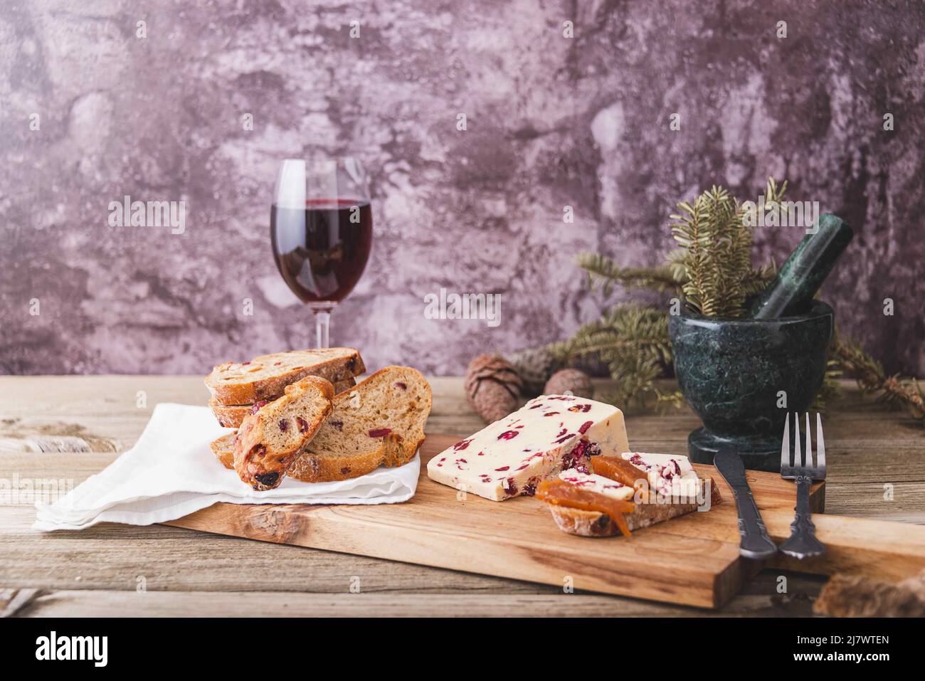 An assortment of various types of cheese with wine, and grapes, shot from above on a dark rustic background with a place for text, square photo. Stock Photo