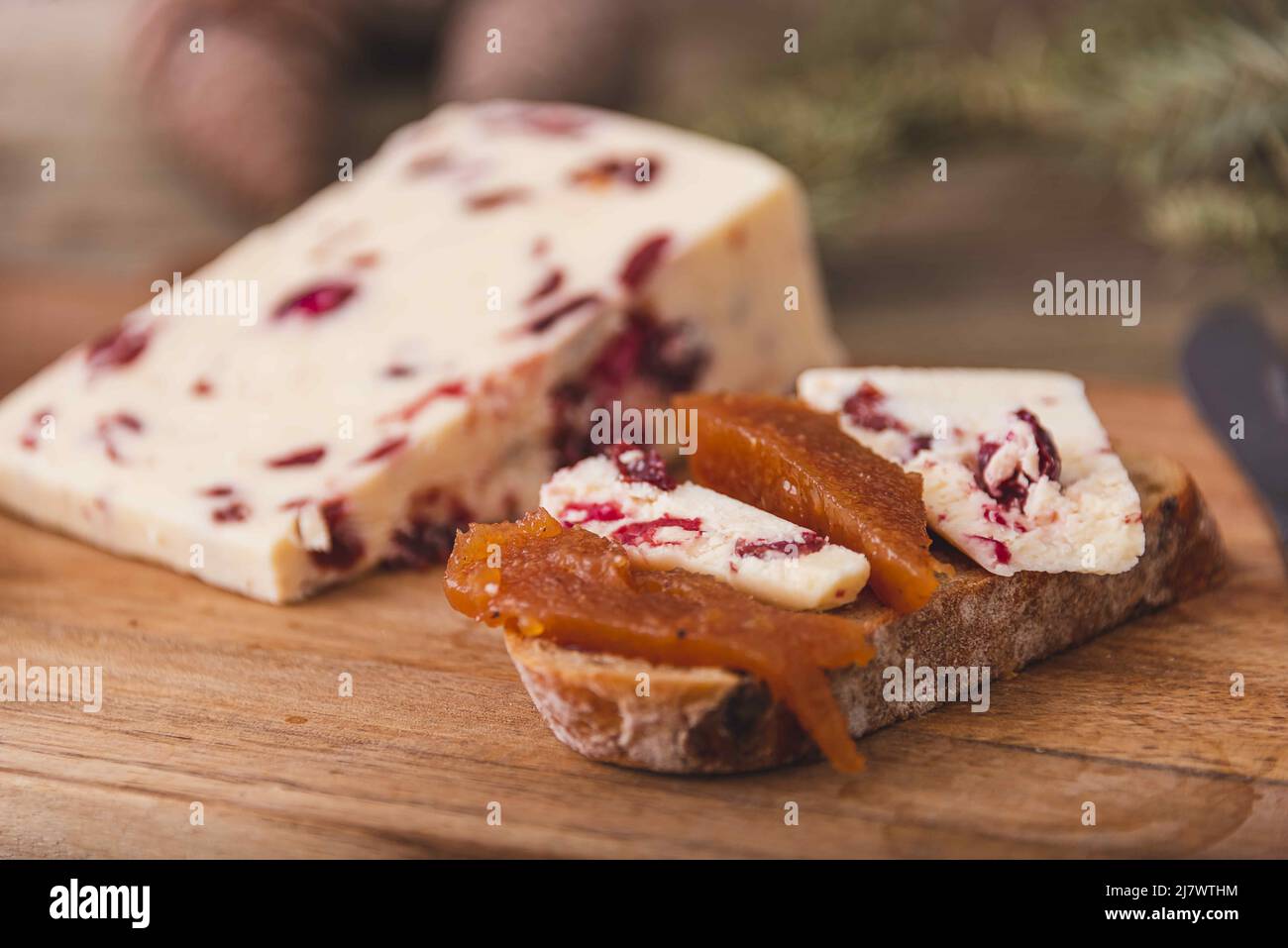 An assortment of various types of cheese with wine, and grapes, shot from above on a dark rustic background with a place for text, square photo. Stock Photo