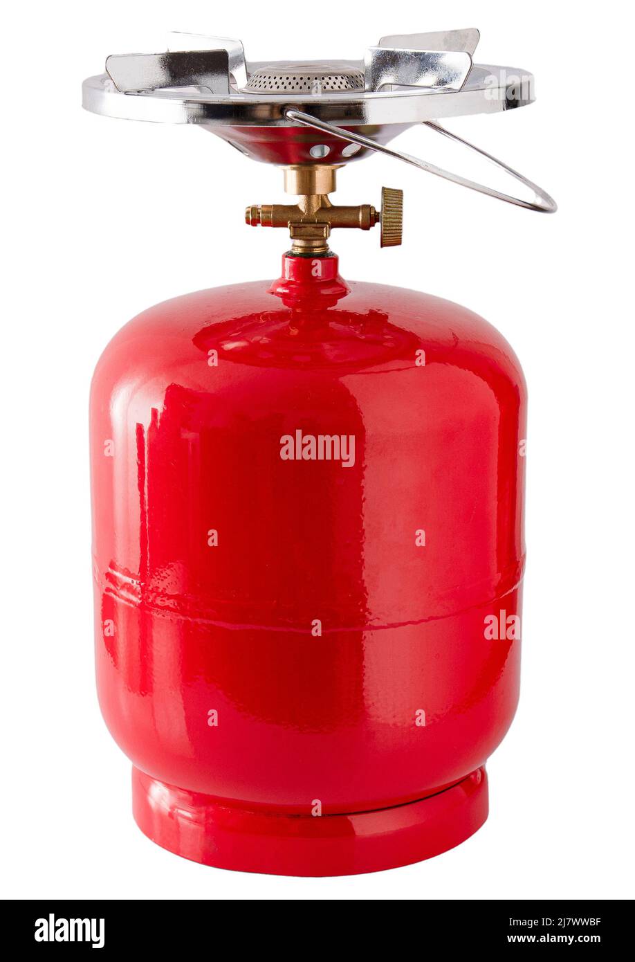 Portable gas bottle. A small compact travel bottle with a burner for cooking on a hike. The road gas stove is filled with propane. Red tank. Stock Photo