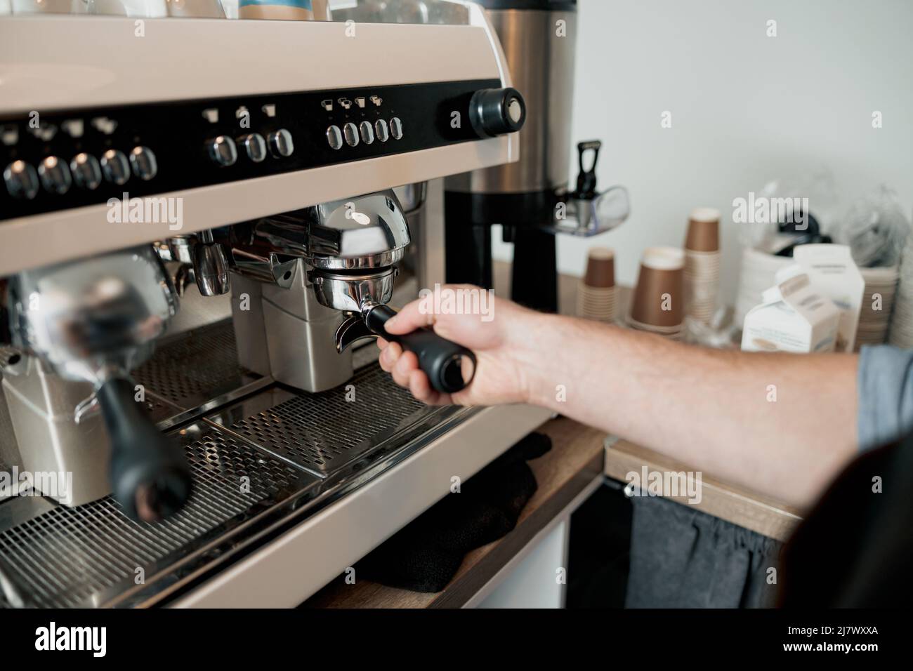 Photo of the process of installing portafilter in coffee machine Stock