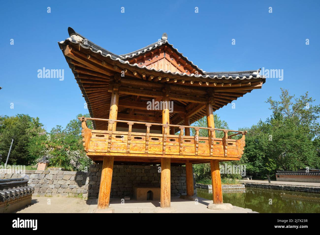 View of a big, wood pagoda by a pond. At the Seoul National Park in Tashkent, Uzbekistan, a bilateral, community greenspace project with Korea. Stock Photo