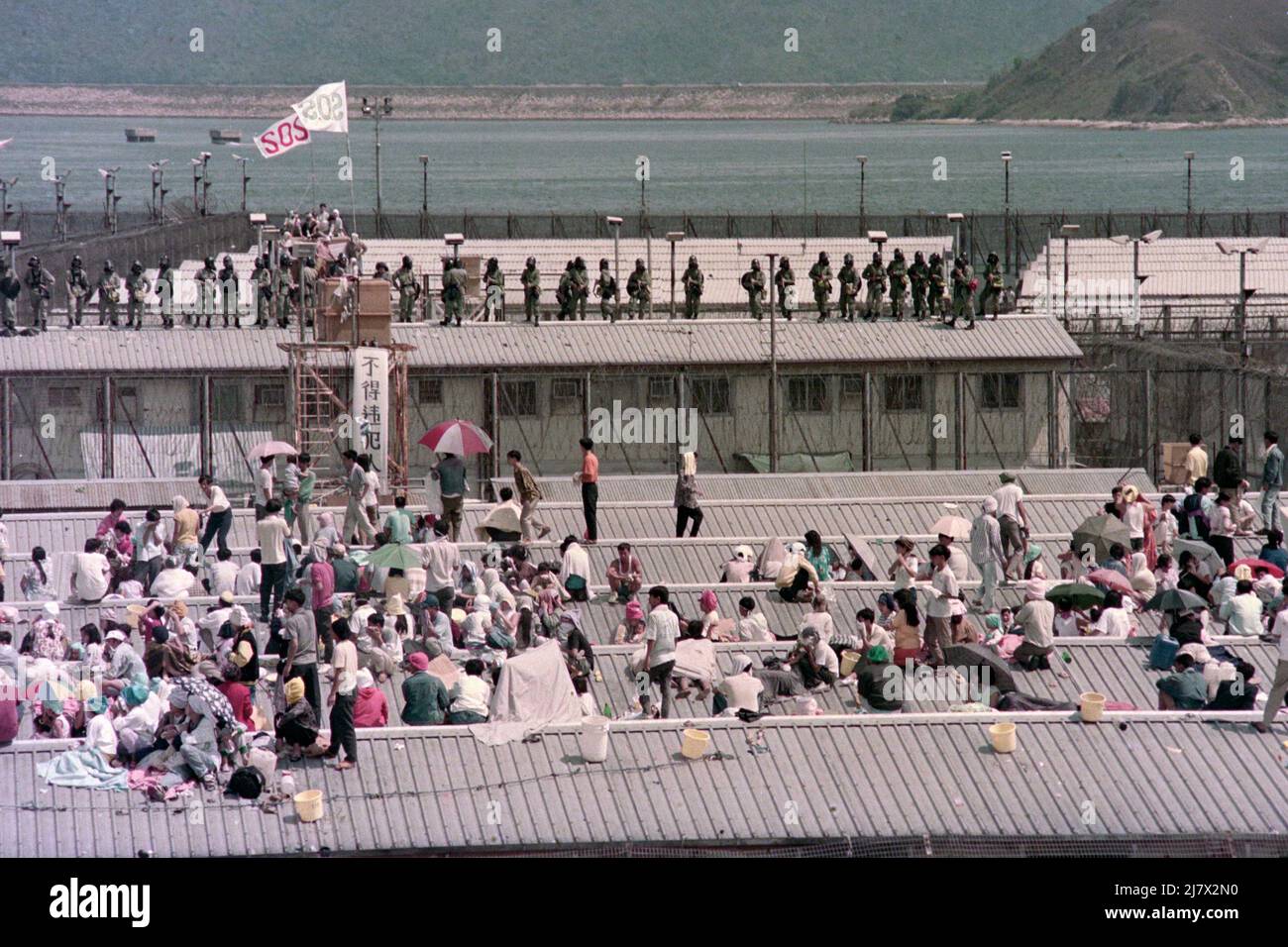 Whitehead Vietnamese Detention Centre, Police clearance operation, April 1994. Some of the Vietnamese Detainees refused to leave the centre and climbed onto the roofs of their blocks.  Tear Smoke (Tear Gas) was eventually used to try to bring them down. Stock Photo