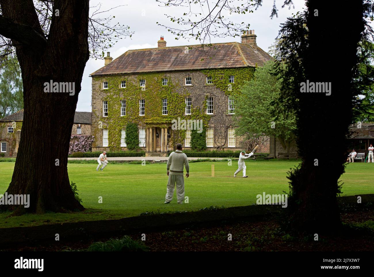 Cricket match in progress in the village of Crakehall, North Yorkshire, England UK Stock Photo