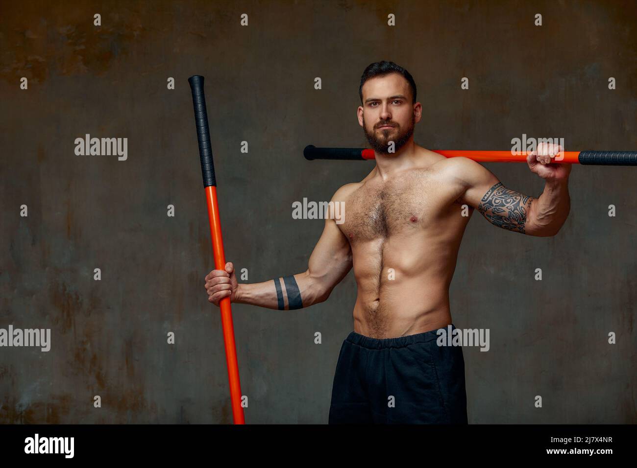 An experienced fighter, stands in a fighting posture with a fighting