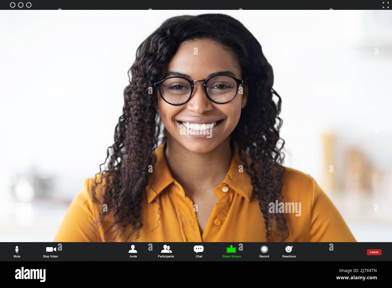 Smiling black woman wearing eyeglasses having video chat Stock Photo