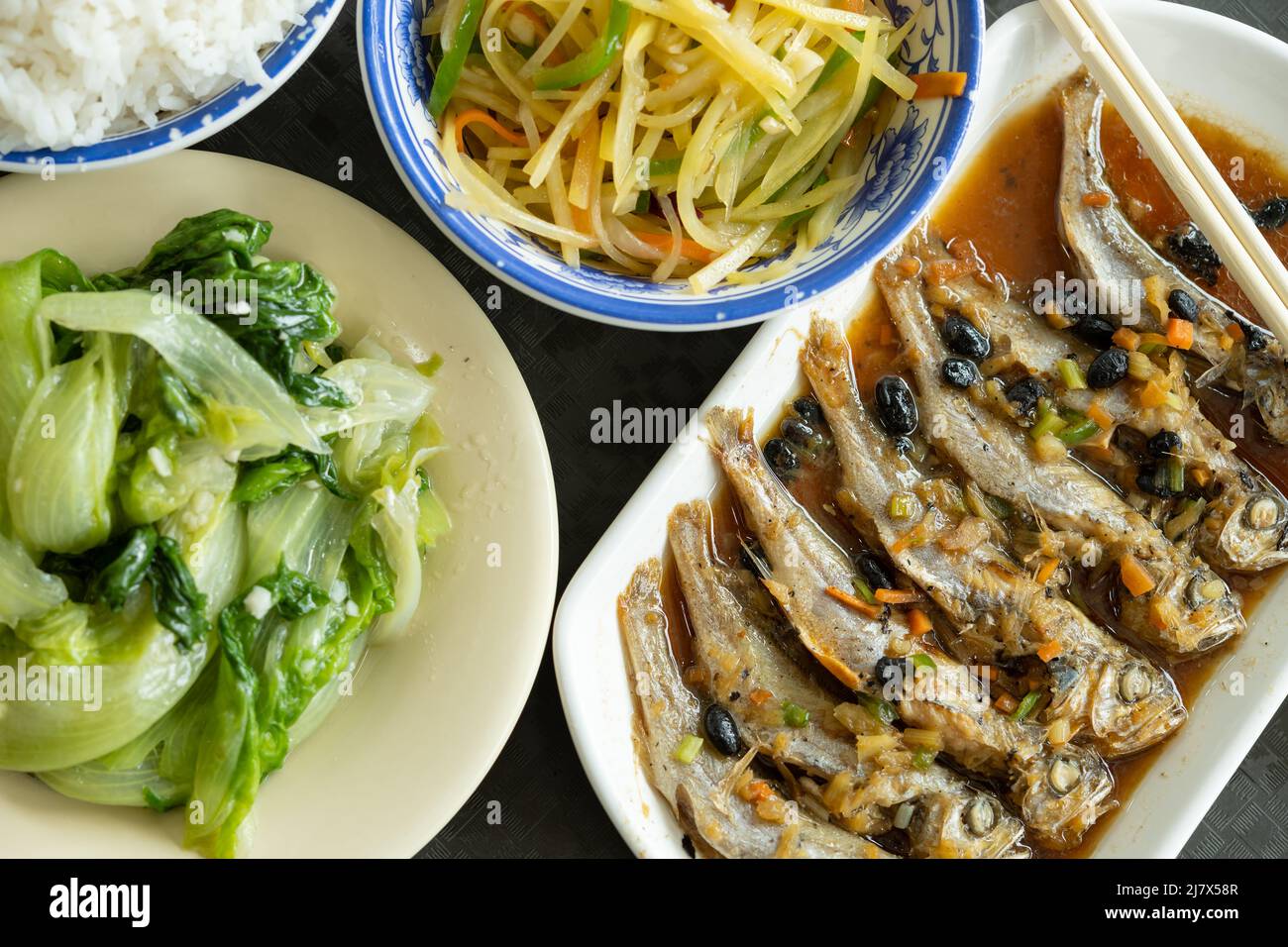 top view fast food of steamed small fishes and cabbage and potato
