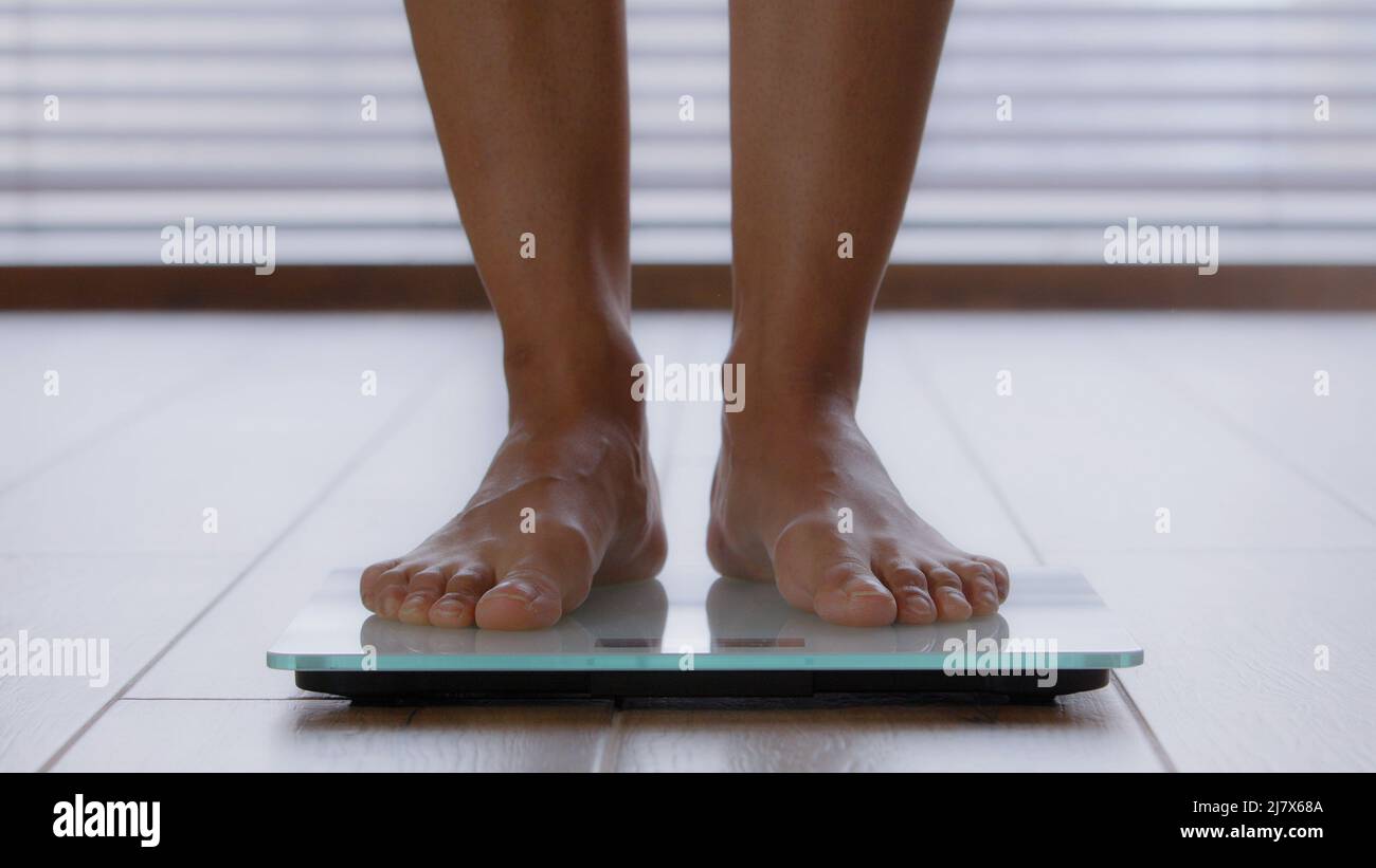 https://c8.alamy.com/comp/2J7X68A/close-up-slender-female-legs-unrecognizable-woman-standing-barefoot-in-bathroom-stepping-on-electronic-scales-checking-weight-after-fat-burning-2J7X68A.jpg