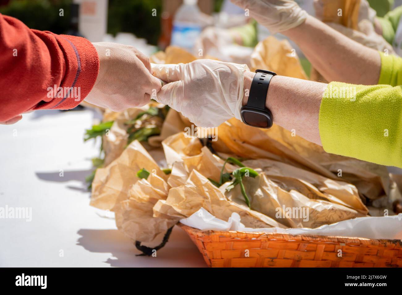 Man paying for purchase on the market of the roasted garlic festival in Arnedo, La Rioja, Spain Stock Photo