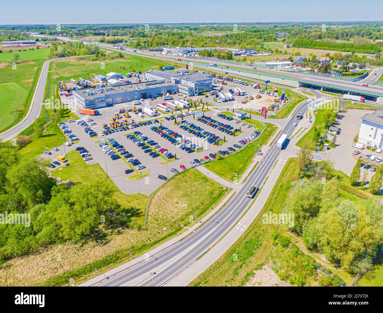 Aerial view of goods warehouse. Logistics center in industrial city zone from above. Aerial view of trucks loading at logistic center Stock Photo