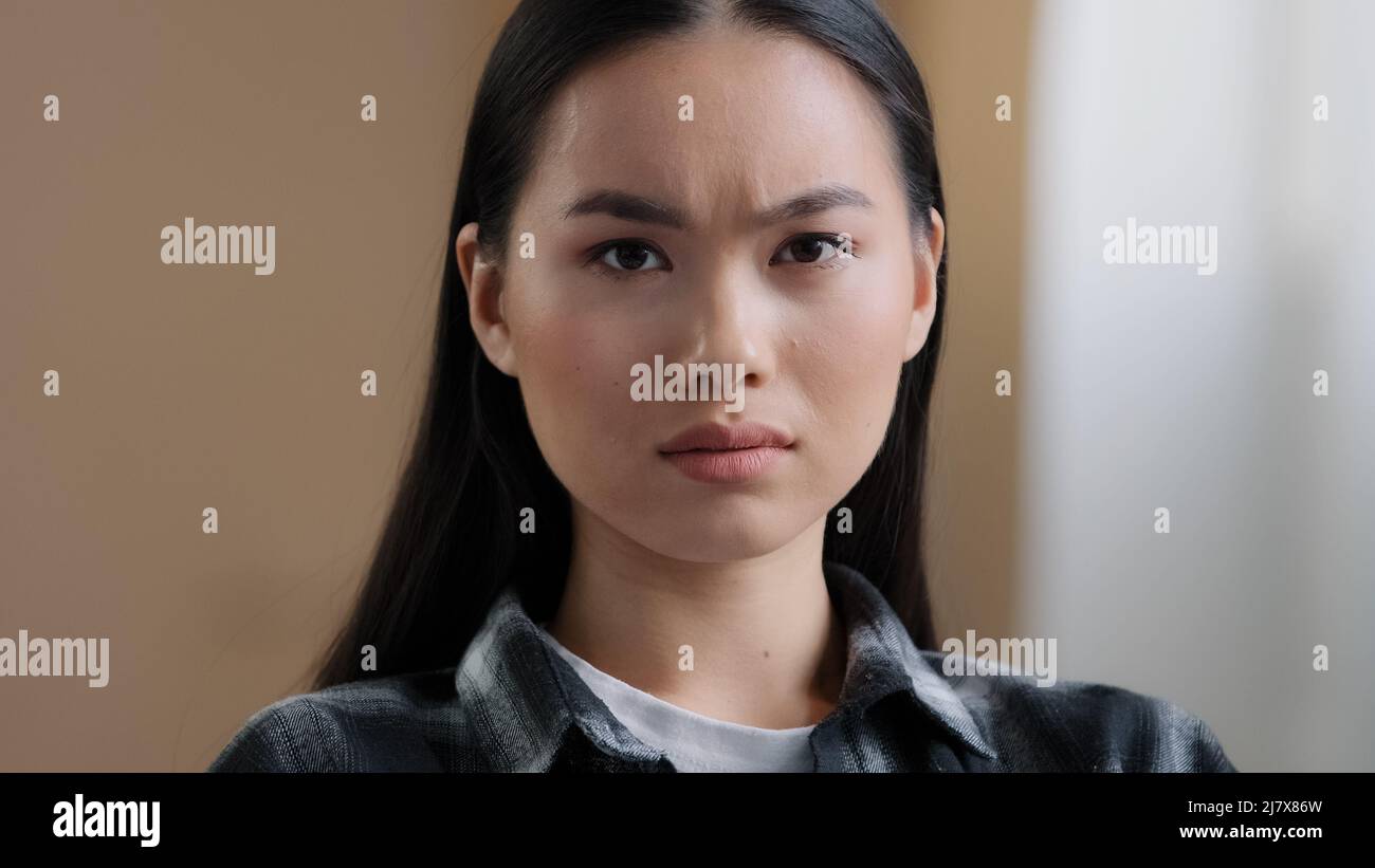 Female emotional portrait Asian girl shock surprise disappointment sadness bad mood negative reaction. Headshot Korean woman looking at camera with Stock Photo