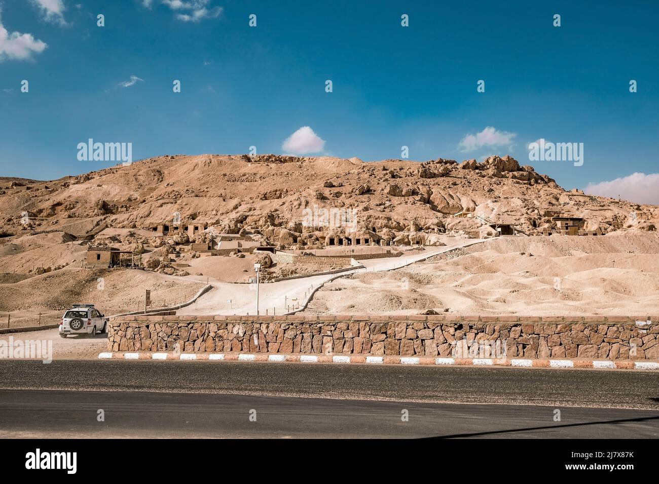 road with a car entering the mountains to the valley of the kings in