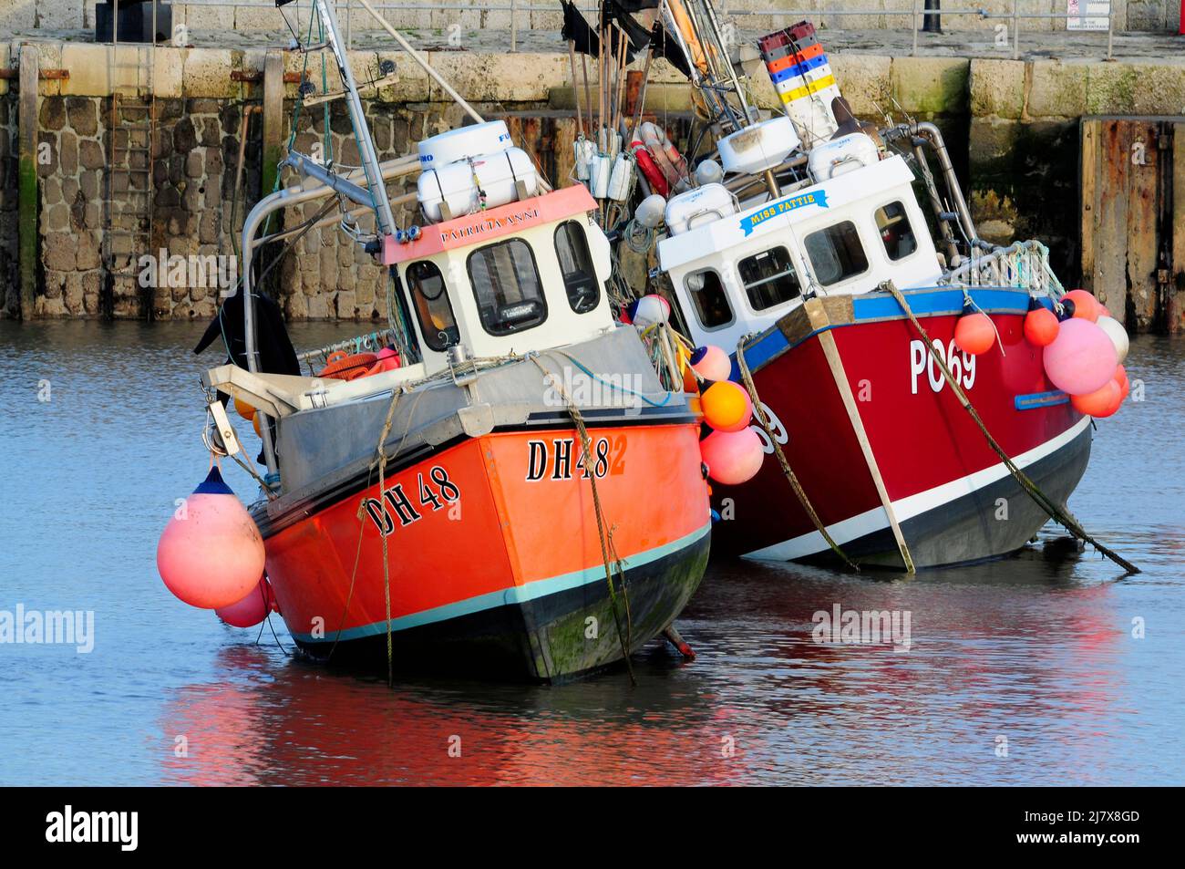 Fishing boats at low tide in Lyme Regis harbour on the Dorset Jurassic