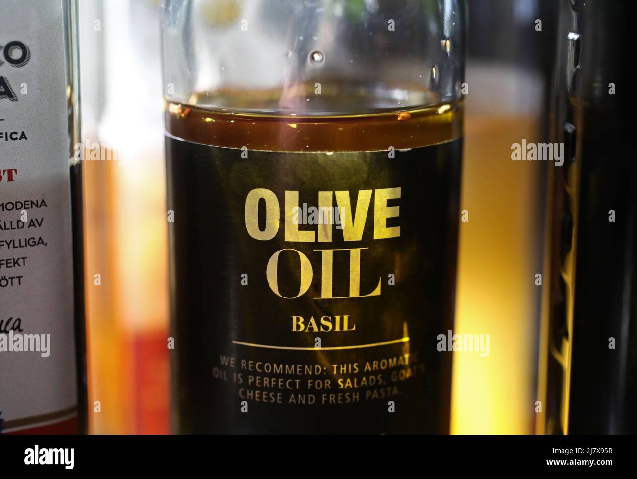 Different kinds of olive oil in a kitchen in a home. Here basil olive