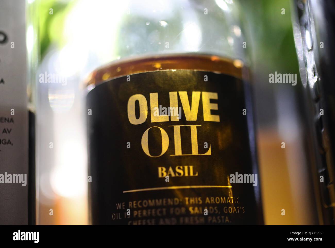 Different kinds of olive oil in a kitchen in a home. Here basil olive